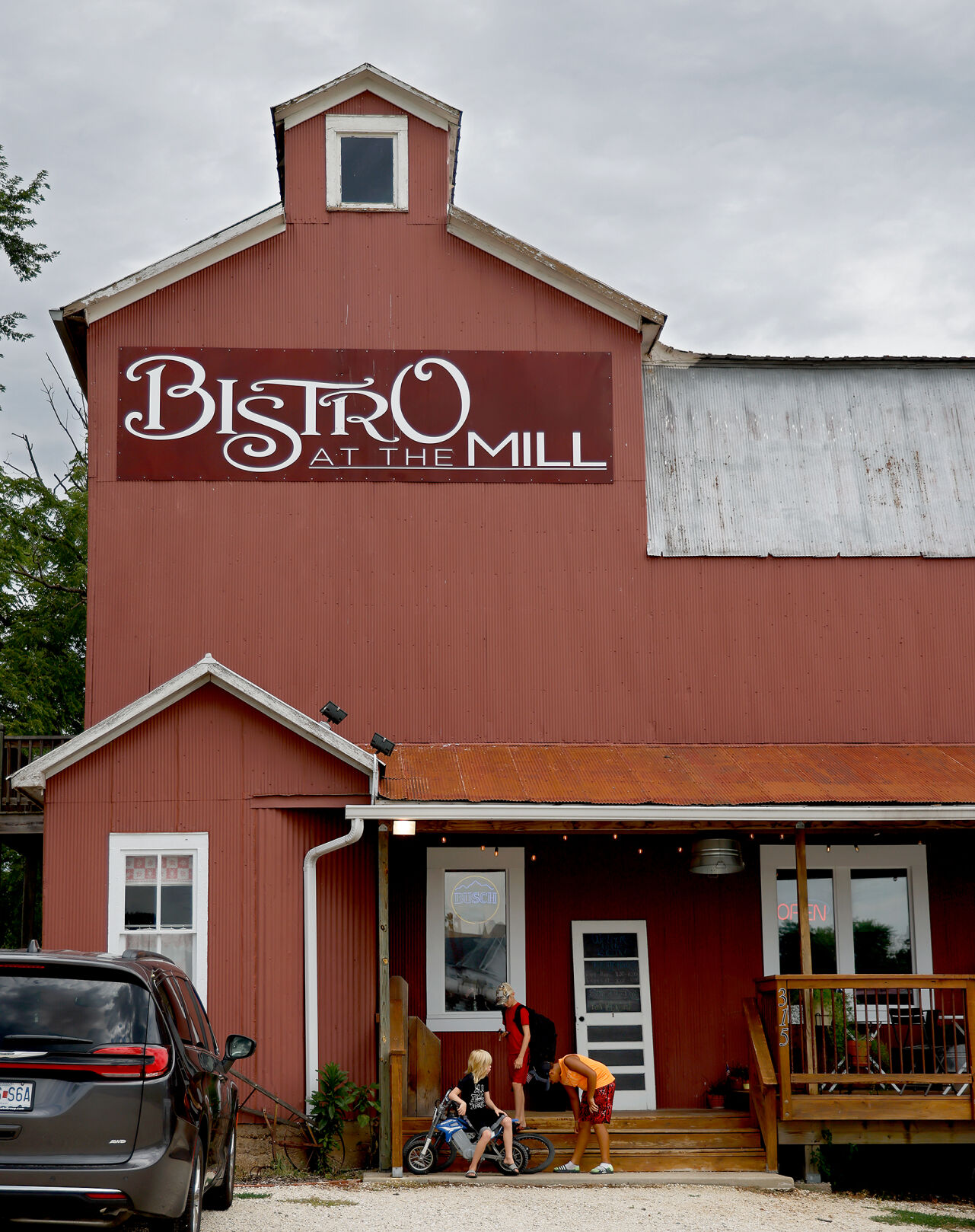 Kids play with each other in front of the Bistro at the Mill